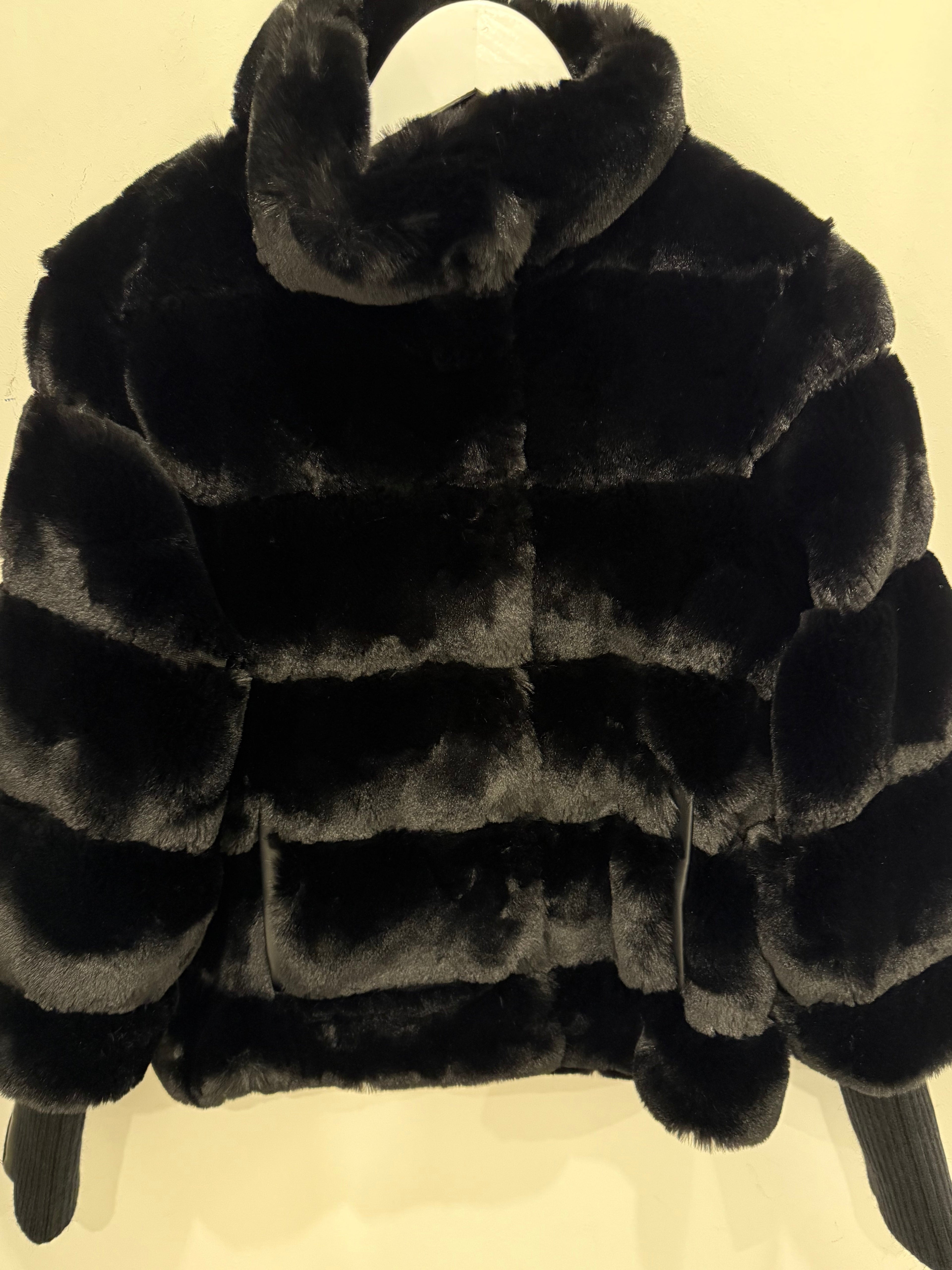 Faux fur jacket with knitted sleeves
